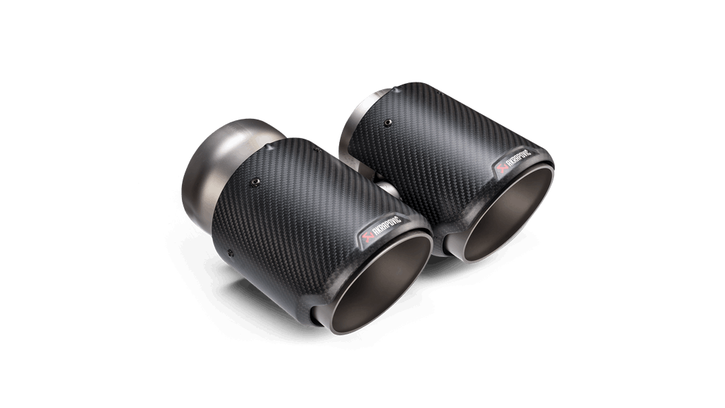 Close up view of a pair of Akrapovic exhaust tail pipe tips in carbon fibre with a round end