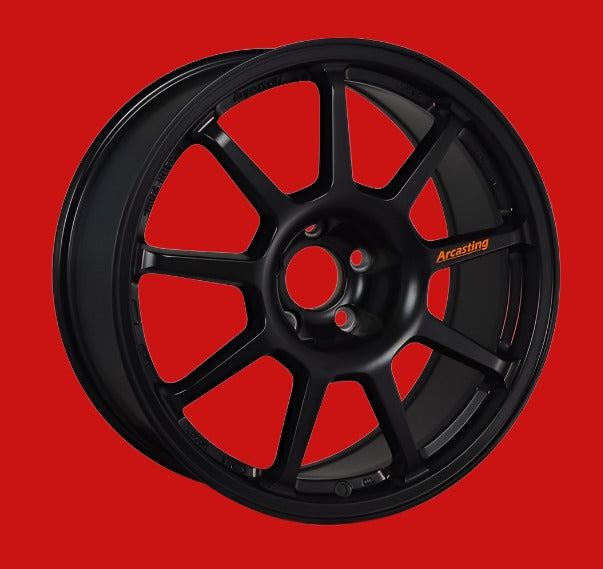 Front view of a Z.A.R Corse 18-inch black wheel with a 9-spoke design against a red background 