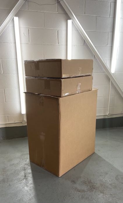 Front view of the 3 boxes required to post the kit, stacked on top of each other 